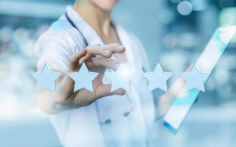 Health worker puts the rating stars on blurred background.