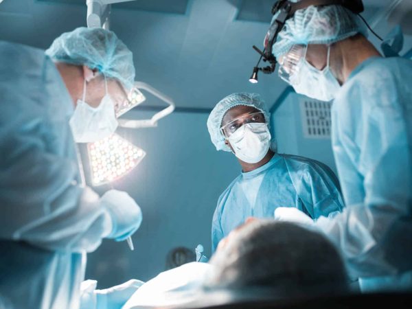 bottom view of multicultural surgeons operating patient in operating room